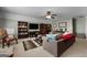 Inviting living room featuring a ceiling fan, plush sofas, and practical built-in shelves at 1561 Aiken Chafin Ln, Mcdonough, GA 30252