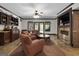 Comfortable living room with a built-in bar, cozy seating, fireplace, and access to the outdoors at 1561 Aiken Chafin Ln, Mcdonough, GA 30252