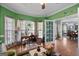 Living room featuring vibrant walls, hardwood floors, and a view into an adjacent dining area at 1561 Aiken Chafin Ln, Mcdonough, GA 30252