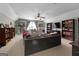 Spacious living room with neutral carpet, ceiling fan, built-in shelves, and a comfortable sofa at 1561 Aiken Chafin Ln, Mcdonough, GA 30252