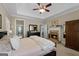 A cozy main bedroom showcasing a fireplace and trey ceiling at 1561 Aiken Chafin Ln, Mcdonough, GA 30252