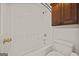 Bathroom featuring a shower and tub combination, white walls, and wood cabinet storage at 85 Bloomfield Way, Sharpsburg, GA 30277
