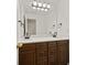 Bathroom featuring a double sink vanity with dark wood cabinets and a large mirror at 85 Bloomfield Way, Sharpsburg, GA 30277