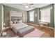 Charming bedroom with bunk beds, desk, ceiling fan, and light green colored walls and hardwood flooring at 85 Bloomfield Way, Sharpsburg, GA 30277
