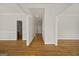 Spacious hallway with hardwood floors, neutral walls, and views into other rooms at 85 Bloomfield Way, Sharpsburg, GA 30277