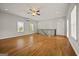 Open living space with hardwood floors flowing into an adjacent dining area and kitchen at 85 Bloomfield Way, Sharpsburg, GA 30277