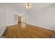 Open living space with hardwood floors flowing into an adjacent dining area and kitchen at 85 Bloomfield Way, Sharpsburg, GA 30277