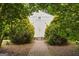 Storage building with double doors and surrounded by shrubbery at 85 Bloomfield Way, Sharpsburg, GA 30277
