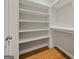 Organized walk-in closet with custom built-in shelving providing ample storage space and functionality at 85 Bloomfield Way, Sharpsburg, GA 30277