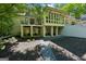 Stunning home exterior showcases a spacious backyard with a screened in porch and lush landscaping at 508 Hastings Dr, Peachtree City, GA 30269
