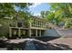 Exterior view of the back of the home showcasing the basement, multi-level living spaces, and manicured landscaping at 508 Hastings Dr, Peachtree City, GA 30269