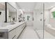 Elegant bathroom featuring double sinks, a sleek vanity, and a glass shower with bench seating at 508 Hastings Dr, Peachtree City, GA 30269