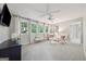 Bright bedroom features a ceiling fan, natural light, and sitting area with chairs at 508 Hastings Dr, Peachtree City, GA 30269