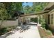 Exterior view of the Porte Cochere and three-car garage with landscaping at 508 Hastings Dr, Peachtree City, GA 30269