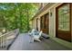 Outdoor deck with two white chairs and black metal railing surrounded by green trees offering privacy at 508 Hastings Dr, Peachtree City, GA 30269