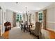 Bright dining room features hardwood floors, an elegant chandelier, and large windows offering views of the landscaped outdoors at 508 Hastings Dr, Peachtree City, GA 30269