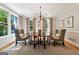 Traditional dining room with chandelier, area rug, neutral walls and bright light from large windows at 508 Hastings Dr, Peachtree City, GA 30269