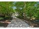 Long driveway winding through lush greenery leading to this lovely home's entrance at 508 Hastings Dr, Peachtree City, GA 30269