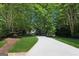 Long driveway winding through lush greenery leading to this lovely home's entrance at 508 Hastings Dr, Peachtree City, GA 30269
