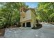 Stunning home exterior with a spacious driveway leading to a two-car garage and lush greenery at 508 Hastings Dr, Peachtree City, GA 30269