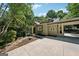 Attractive home exterior with covered carport, large driveway, front porch, and mature trees at 508 Hastings Dr, Peachtree City, GA 30269