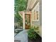 Inviting front entrance with a wood door, stone pathway, and manicured landscaping at 508 Hastings Dr, Peachtree City, GA 30269