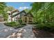 Charming home showcasing meticulous landscaping, stone walkway, and a welcoming front porch with classic American flag at 508 Hastings Dr, Peachtree City, GA 30269