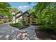 Charming home showcasing meticulous landscaping, stone walkway, and a welcoming front porch with classic American flag at 508 Hastings Dr, Peachtree City, GA 30269