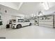 Clean, well-lit garage featuring white walls, a white car, and multiple garage doors at 508 Hastings Dr, Peachtree City, GA 30269
