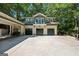 Expansive three-car garage with a driveway, balcony, and a connecting port cochere at 508 Hastings Dr, Peachtree City, GA 30269