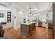 Bright kitchen with an island, wooden bar stools, ample cabinet space, and terracotta tile floors at 508 Hastings Dr, Peachtree City, GA 30269
