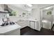 Bright kitchen features white cabinets, modern appliances, and windows that illuminate the space at 508 Hastings Dr, Peachtree City, GA 30269