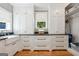 The laundry room has white cabinets and black countertops with under-mount sink and a bright window at 508 Hastings Dr, Peachtree City, GA 30269