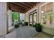Inviting outdoor patio with exposed wood beams offers a relaxing space with comfortable seating and a view of nature at 508 Hastings Dr, Peachtree City, GA 30269