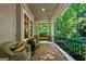 Relaxing porch with swing and wicker chairs overlooking lush greenery, a perfect outdoor retreat at 508 Hastings Dr, Peachtree City, GA 30269