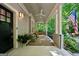 Relaxing porch features comfortable seating, a swing, and view of the surrounding greenery, perfect for outdoor enjoyment at 508 Hastings Dr, Peachtree City, GA 30269