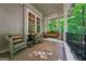 Inviting porch with wicker seating and a swing offers a tranquil spot to enjoy views of the surrounding greenery at 508 Hastings Dr, Peachtree City, GA 30269