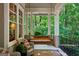 Charming porch offers a cozy swing, wicker chairs, and serene views of the lush greenery, ideal for relaxing outdoors at 508 Hastings Dr, Peachtree City, GA 30269