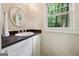 Elegant powder room with a stylish sink and a window with views of nature at 508 Hastings Dr, Peachtree City, GA 30269