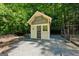 Close-up of a well maintained backyard shed featuring a painted front door at 508 Hastings Dr, Peachtree City, GA 30269
