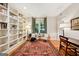 Charming study with hardwood floors, built-in bookshelves, a cozy sitting area, and lots of natural light at 508 Hastings Dr, Peachtree City, GA 30269