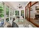 Bright sunroom features white wood paneled ceilings, large windows, and comfortable seating with views of the outdoors at 508 Hastings Dr, Peachtree City, GA 30269
