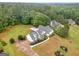 A beautiful aerial shot displays a well-maintained home with a large yard, complemented by mature trees and greenery at 506 Brewer Dr, Locust Grove, GA 30248