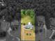 A stunning aerial view showcases the charming home with expansive lawn, surrounded by lush greenery and mature trees at 506 Brewer Dr, Locust Grove, GA 30248