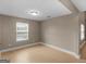 A neutral bedroom featuring a window and light wood-look flooring, creating a blank canvas at 506 Brewer Dr, Locust Grove, GA 30248