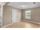 A neutral bedroom with light wood-look flooring, a window, and a closet at 506 Brewer Dr, Locust Grove, GA 30248