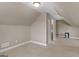 Spacious bonus room with neutral carpet and paint, featuring an adjacent room with a door at 506 Brewer Dr, Locust Grove, GA 30248