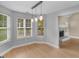Bright dining room with wood floor, modern lighting, and view into the fireplace and living room at 506 Brewer Dr, Locust Grove, GA 30248