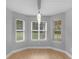 Light-filled dining area with a bay of windows offering a serene view of the lush, green lawn at 506 Brewer Dr, Locust Grove, GA 30248