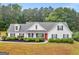 Charming one-story home with a landscaped front yard and a red front door at 506 Brewer Dr, Locust Grove, GA 30248